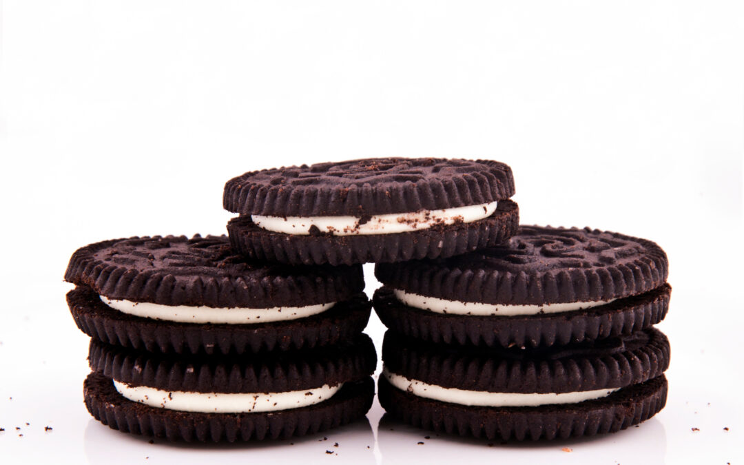 five dark chocolate sandwich cookies stacked