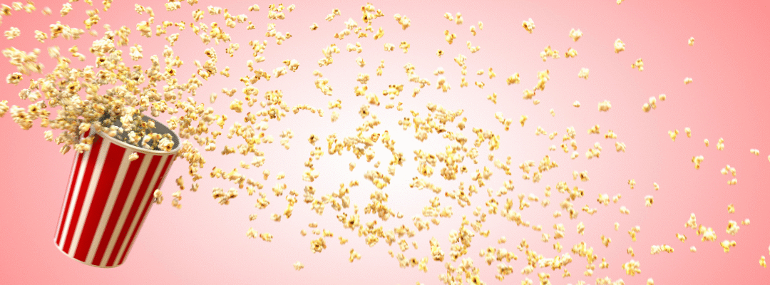 popcorn spilling across pink background