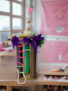 A tree-house like structure made out of upcycled cardboard tubes and feathers